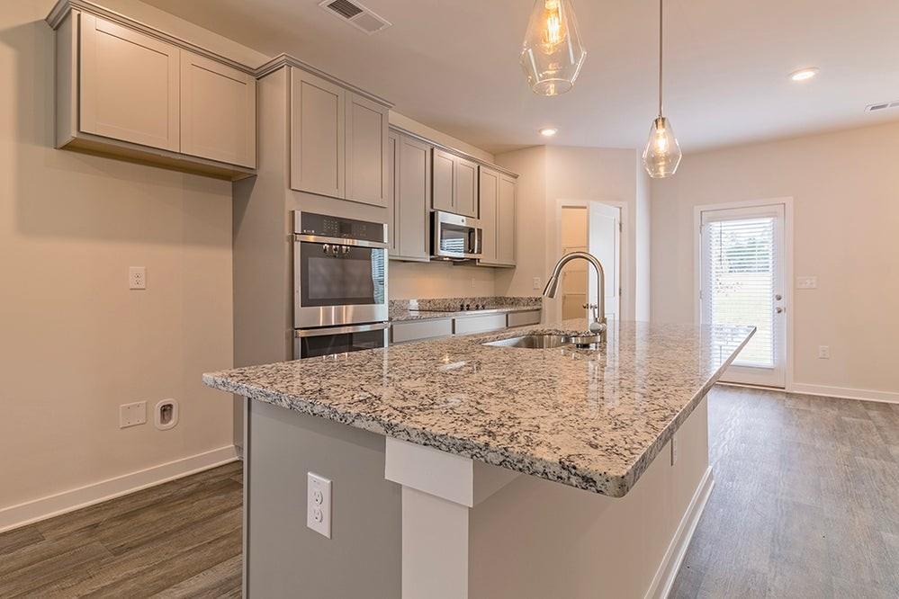 148 Post Oak Drive Jackson, GA 30233 - Photo 7 of 20 a kitchen with stainless steel appliances granite countertop a sink refrigerator and cabinets