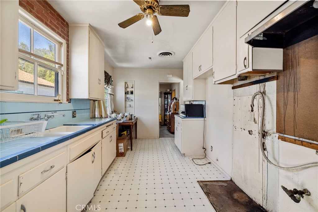 17650 Welby Way Lake Balboa, CA 91406 - Photo 11 of 38 a kitchen with a sink and white cabinets