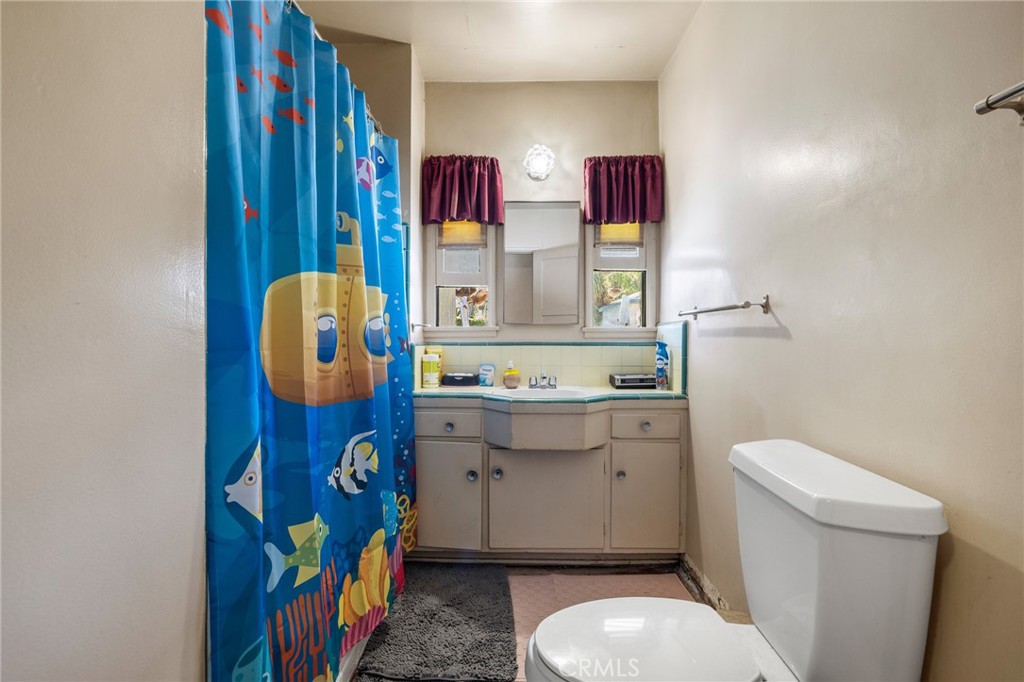 17650 Welby Way Lake Balboa, CA 91406 - Photo 24 of 38 a bathroom with a toilet sink vanity granite and mirror