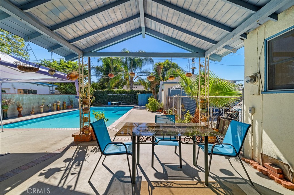 17650 Welby Way Lake Balboa, CA 91406 - Photo 26 of 38 a view of a patio with table and chairs under an umbrella