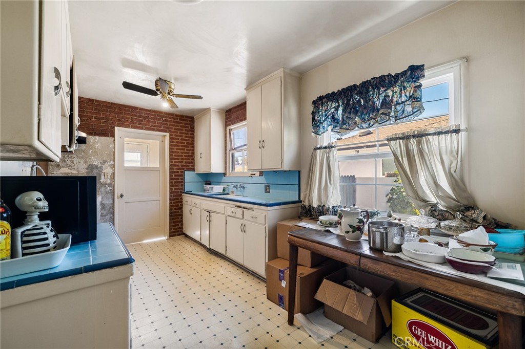 17650 Welby Way Lake Balboa, CA 91406 - Photo 9 of 38 a kitchen with sink cabinets and window