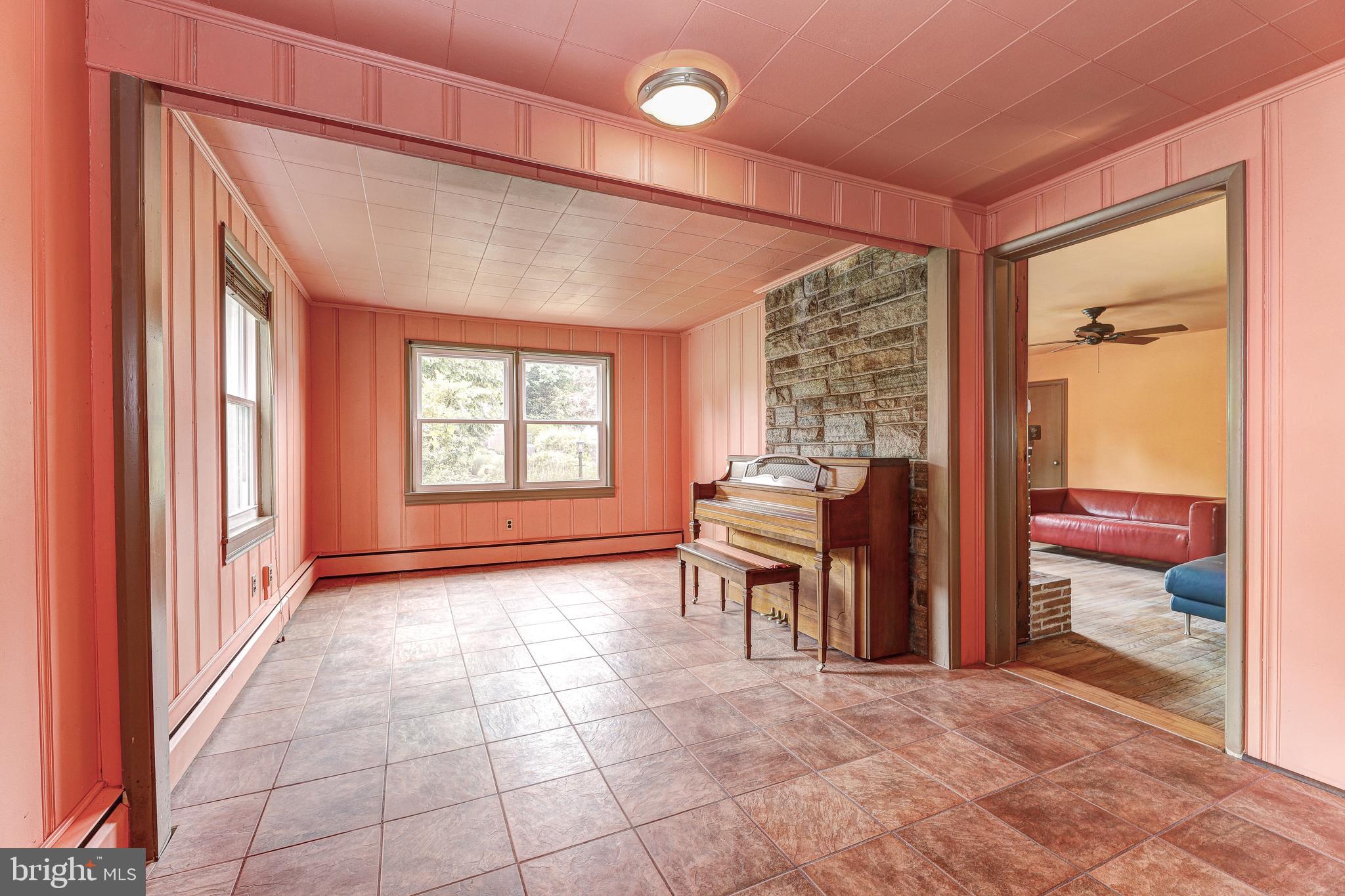 7500 Rocksham Drive Towson, MD 21286 - Photo 7 of 26 a view of an empty room with a birdcage and a window
