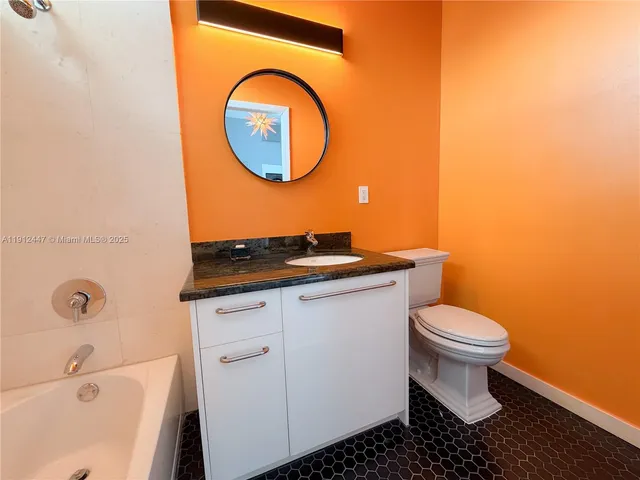 a bathroom with a toilet a sink and a mirror