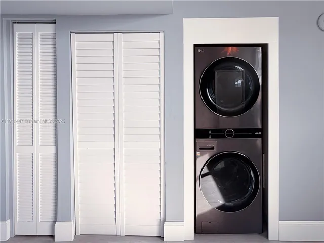 a close view of a utility room with dryer and washer