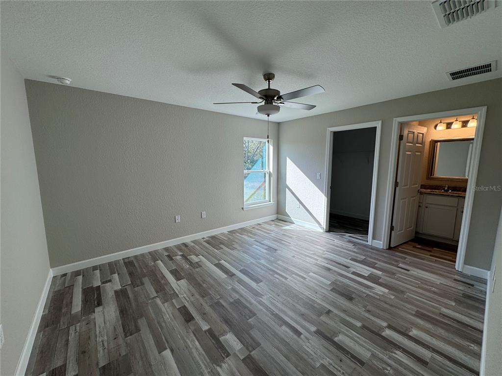 14136 Southwest 33rd Court Road Ocala, FL 34473 - Photo 8 of 10 wooden floor in an empty room with a window