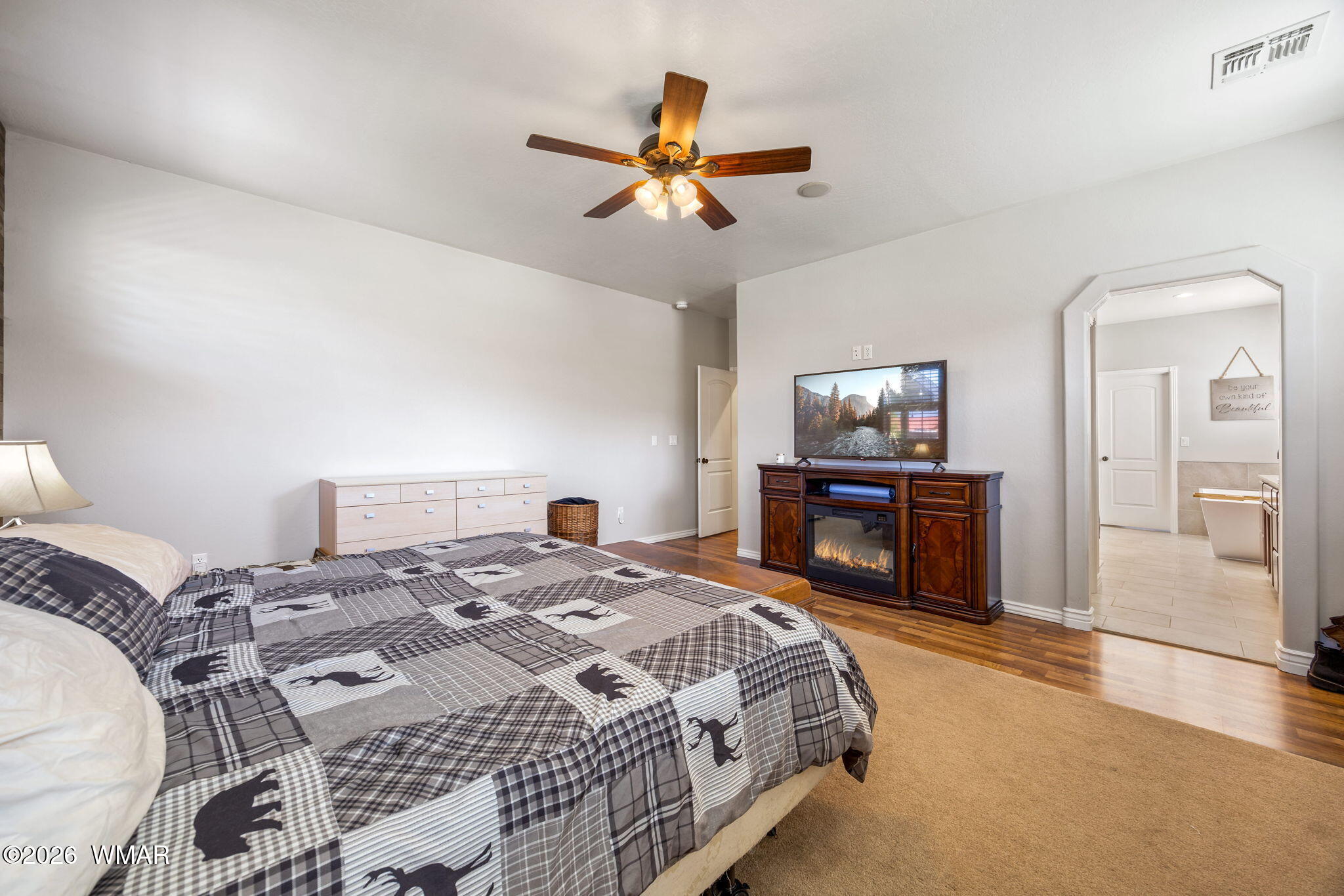 1940 Stonegate Way Heber, AZ 85928 - Photo 23 of 62 a bedroom with a bed and a chandelier