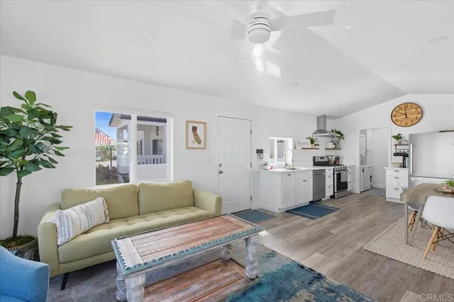 a living room with furniture a chandelier and a window