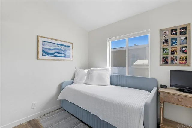 a bedroom with a large bed and a tv