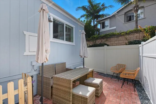 a backyard of a house with table and chairs