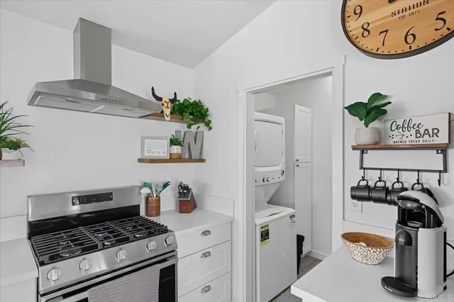 a kitchen with a stove and a clock