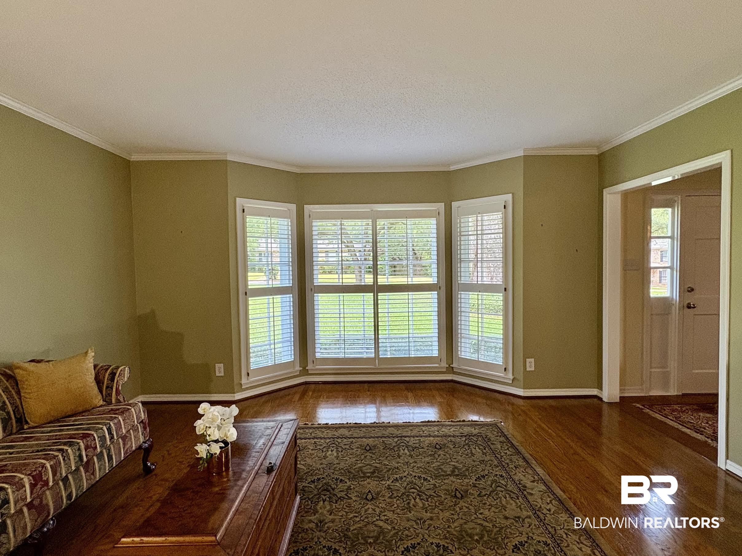 6105 Brandy Run Road South Mobile, AL 36608 - Photo 6 of 45 Unfurnished living room with wood finished floors, crown molding, and baseboards