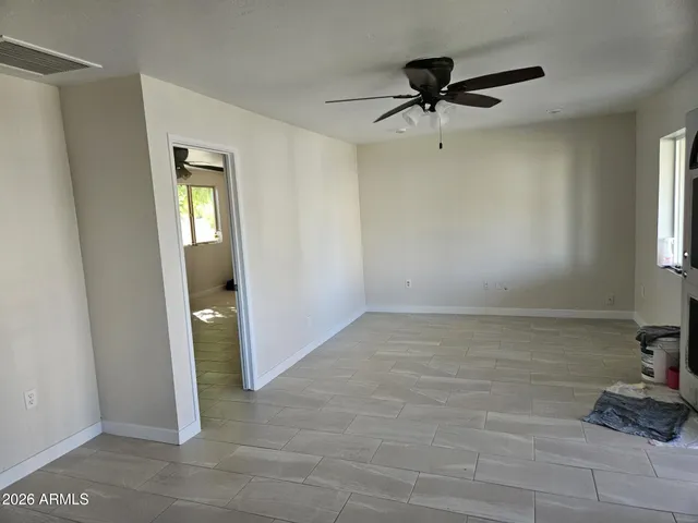 a view of a livingroom with a ceiling fan and window
