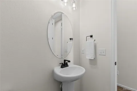 a bathroom with a sink a toilet and mirror