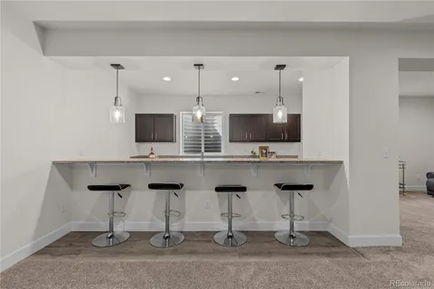 a kitchen with stainless steel appliances kitchen island granite countertop a sink and a microwave