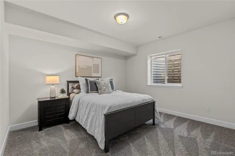 a spacious bedroom with a bed and window