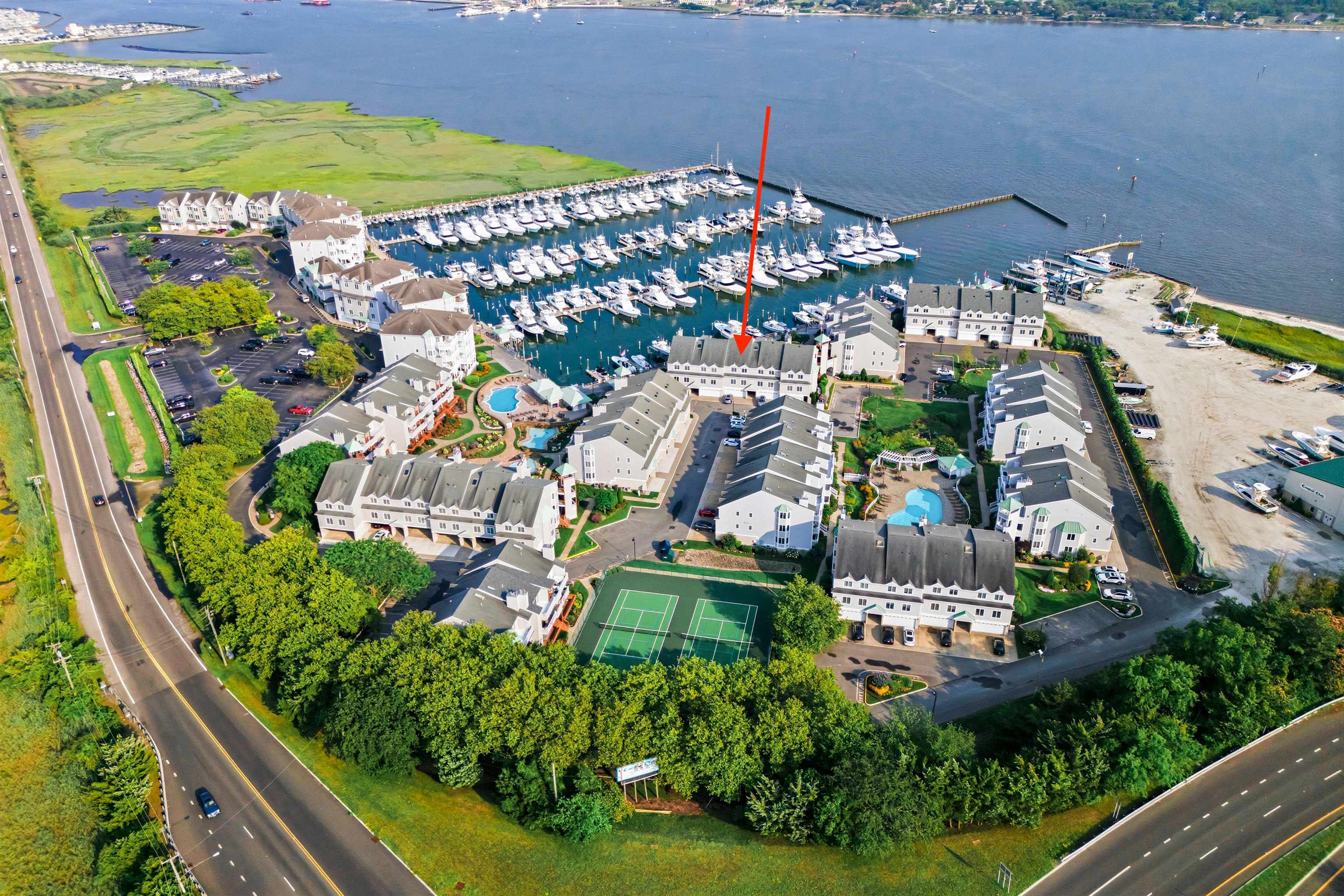 an aerial view of residential houses with outdoor space and swimming pool