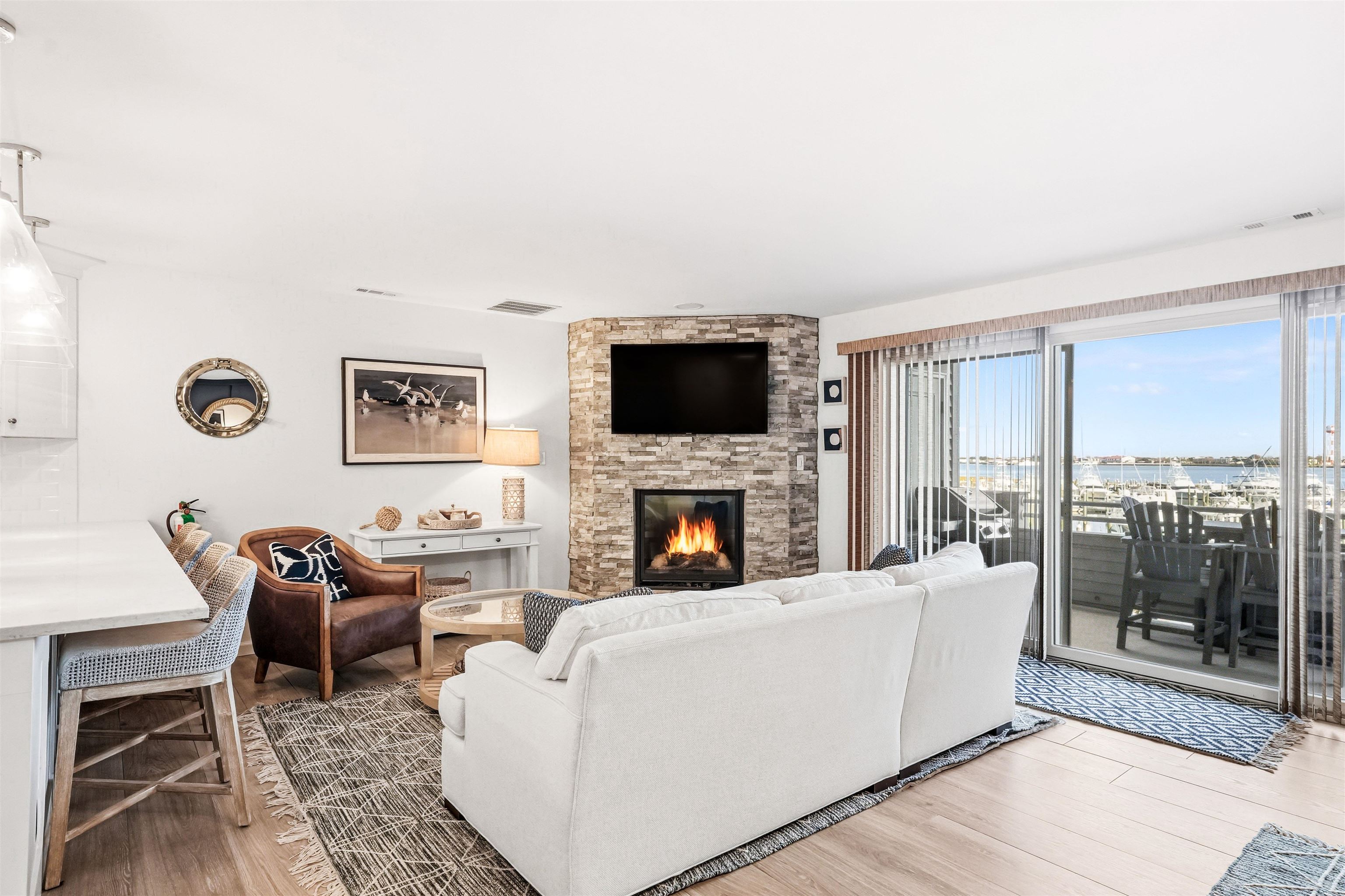 902 Ocean, Unit 906 Cape May, NJ 08204 - Photo 13 of 47 a living room with furniture a fireplace and a flat screen tv