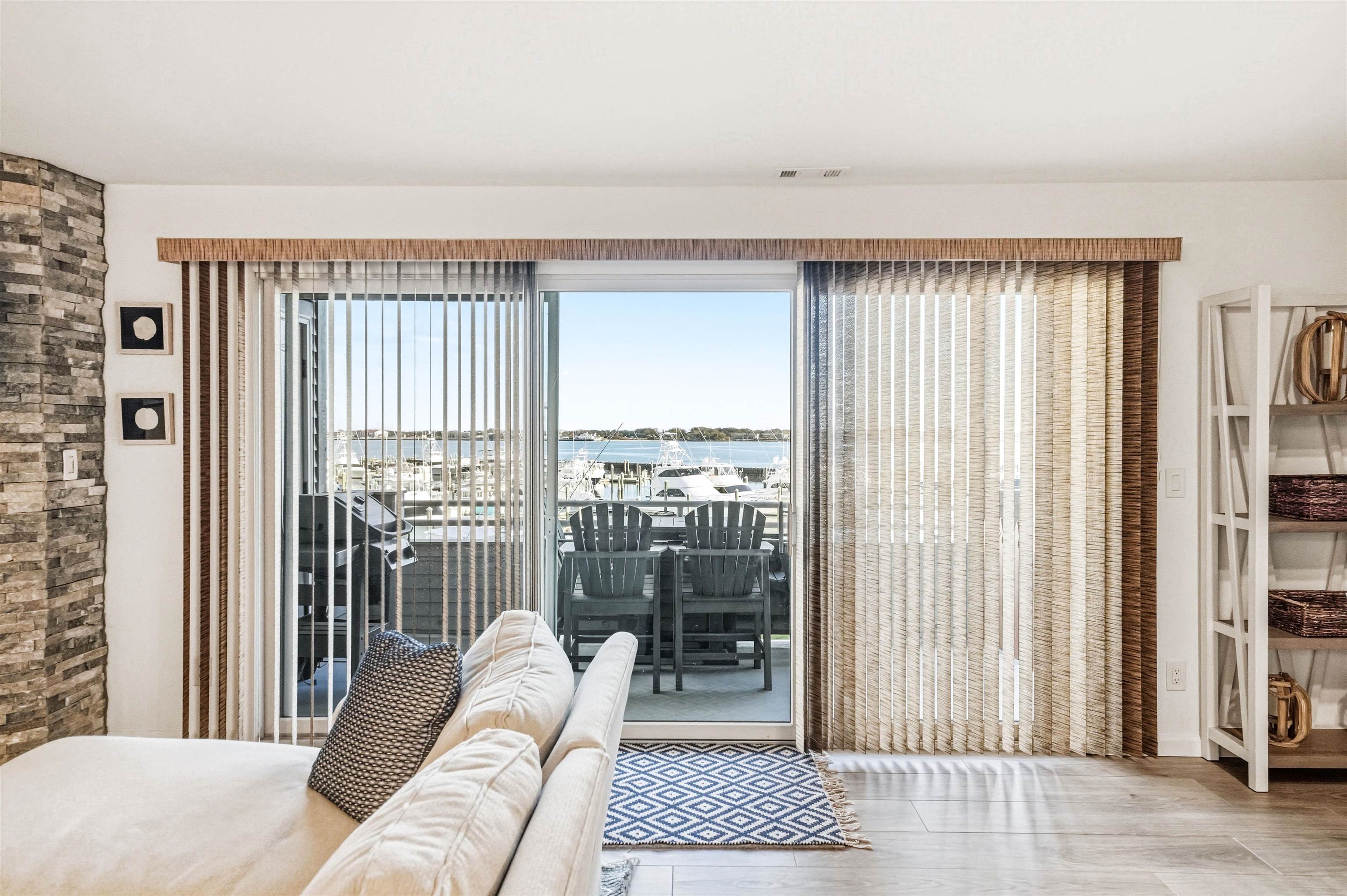902 Ocean, Unit 906 Cape May, NJ 08204 - Photo 17 of 47 a living room with furniture and a floor to ceiling window