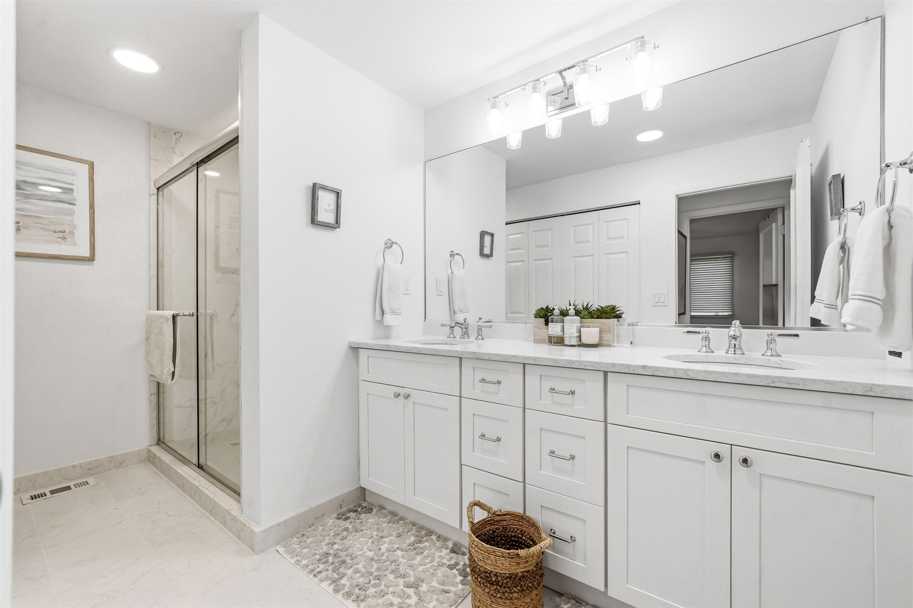 902 Ocean, Unit 906 Cape May, NJ 08204 - Photo 24 of 47 a spacious bathroom with a shower sink and mirror