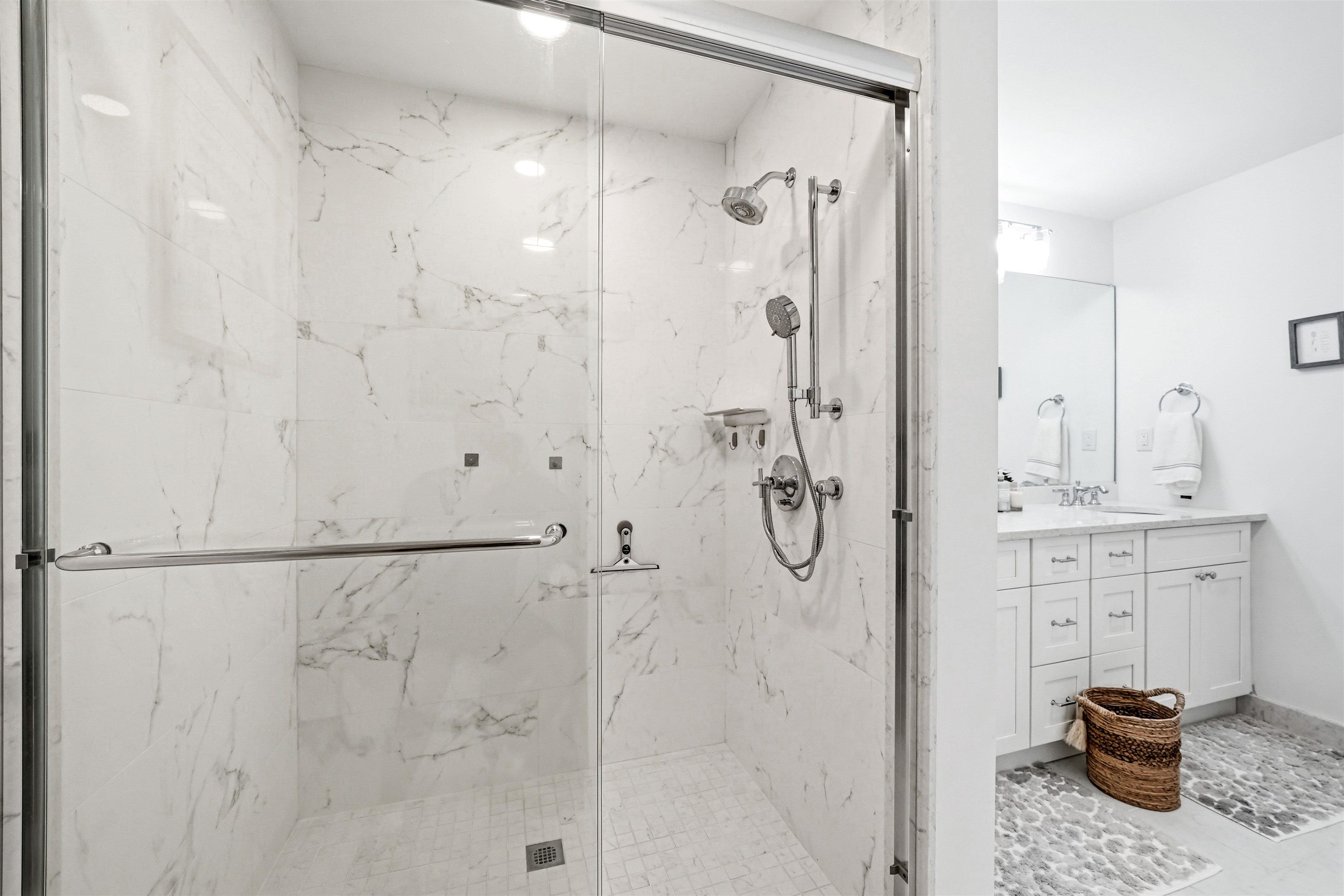 902 Ocean, Unit 906 Cape May, NJ 08204 - Photo 25 of 47 a bathroom with a granite countertop shower sink and mirror