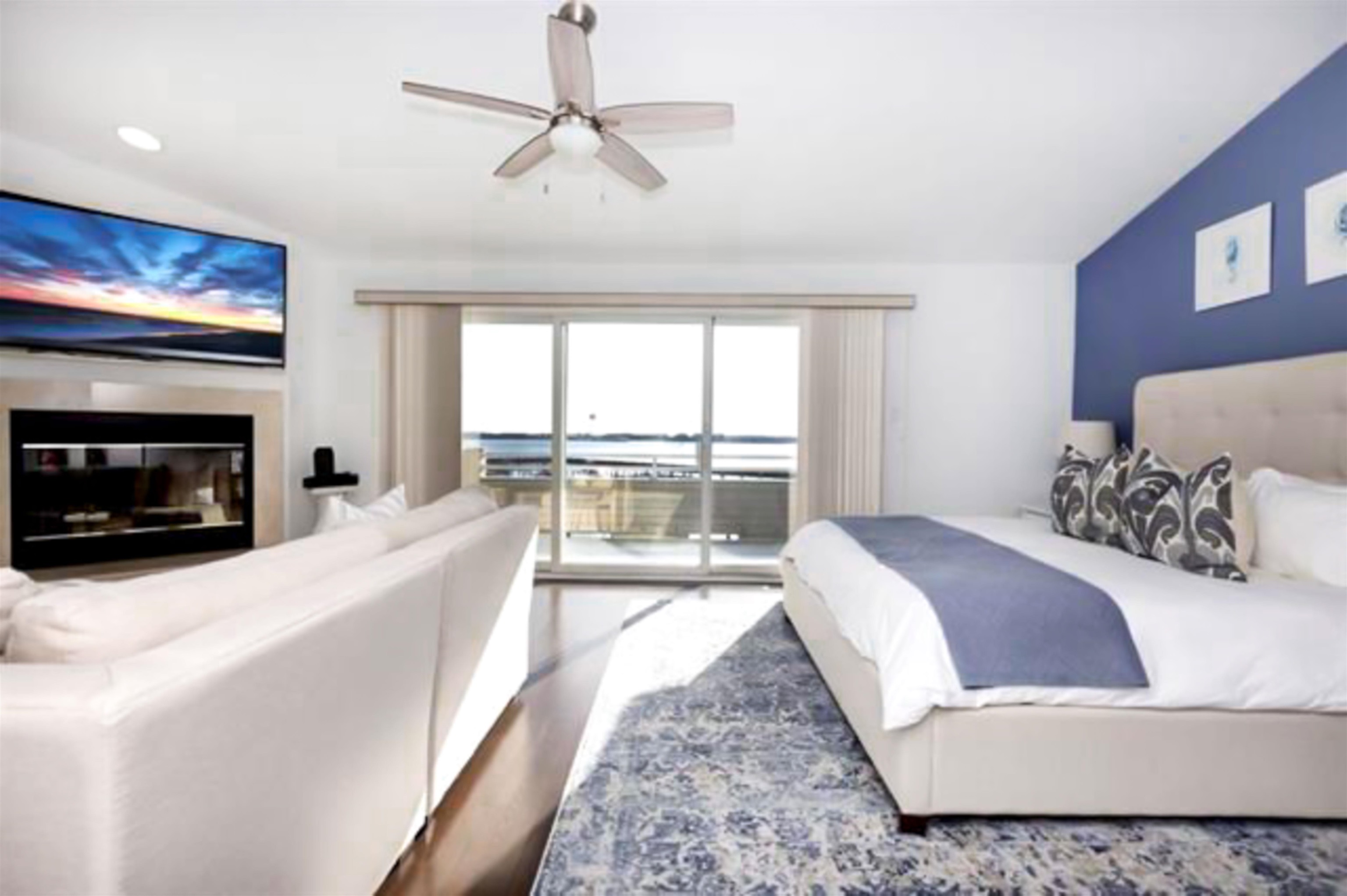 902 Ocean, Unit 906 Cape May, NJ 08204 - Photo 27 of 47 a living room with a balcony furniture and a fireplace