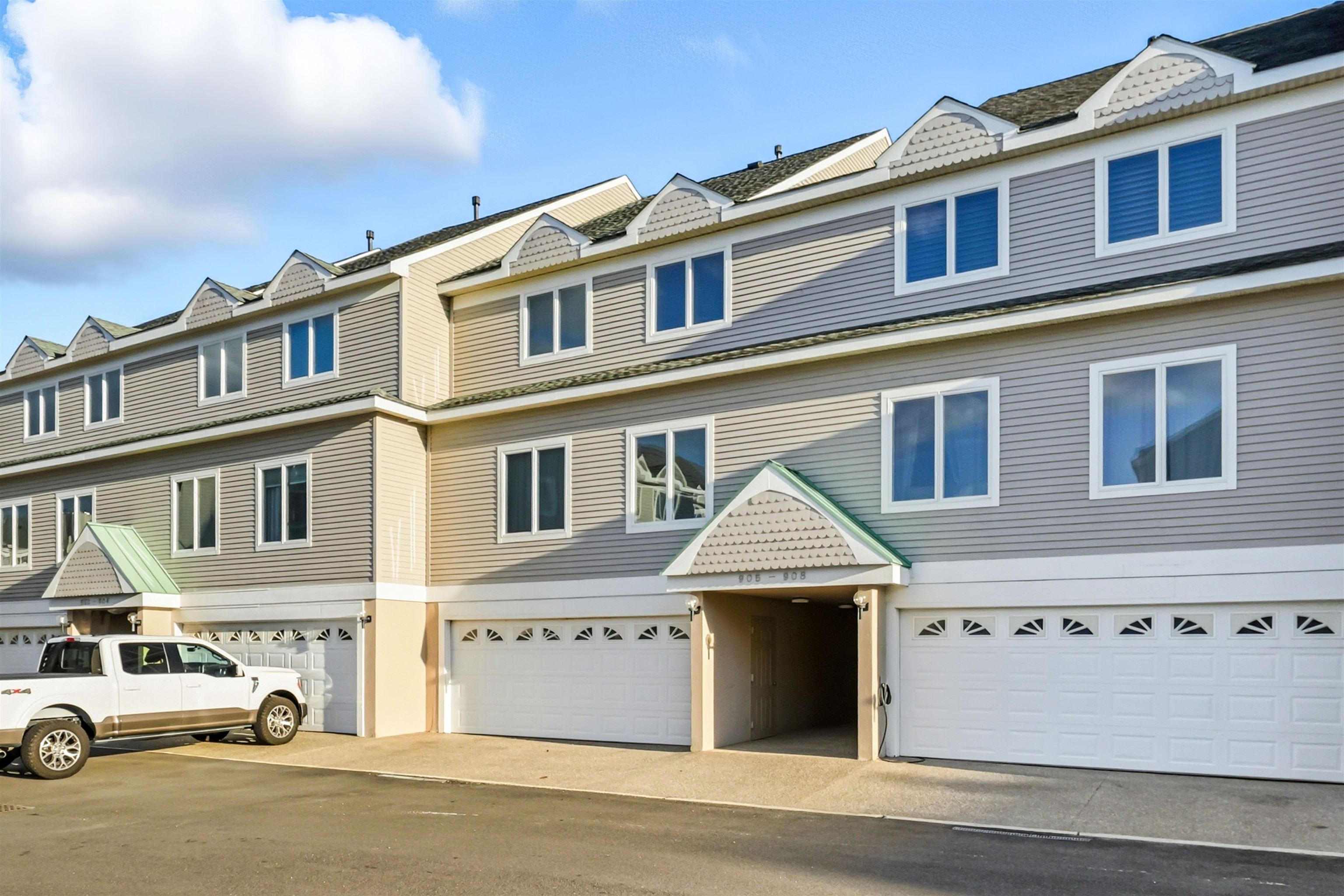 902 Ocean, Unit 906 Cape May, NJ 08204 - Photo 3 of 47 a front view of a residential apartment building with a yard
