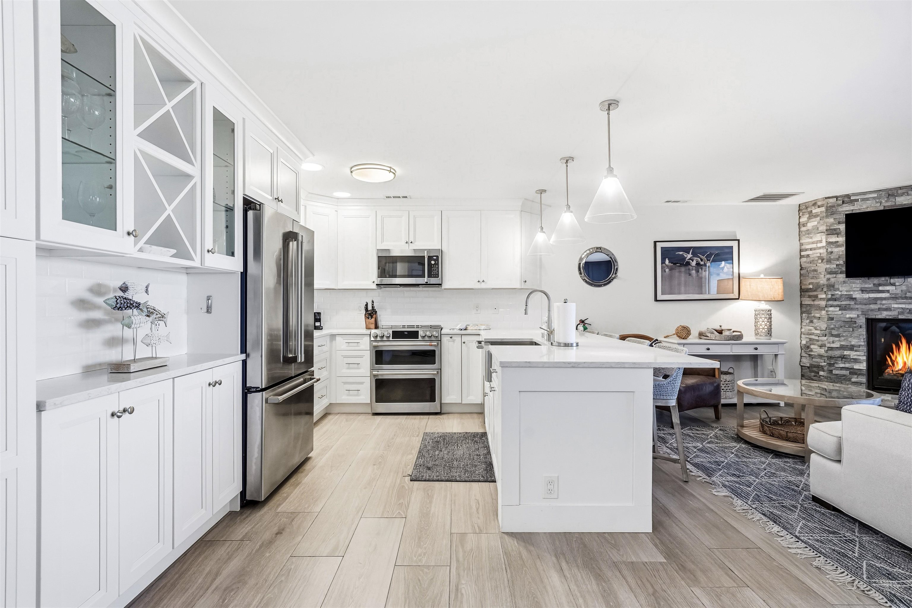 902 Ocean, Unit 906 Cape May, NJ 08204 - Photo 8 of 47 a kitchen with white cabinets and stainless steel appliances