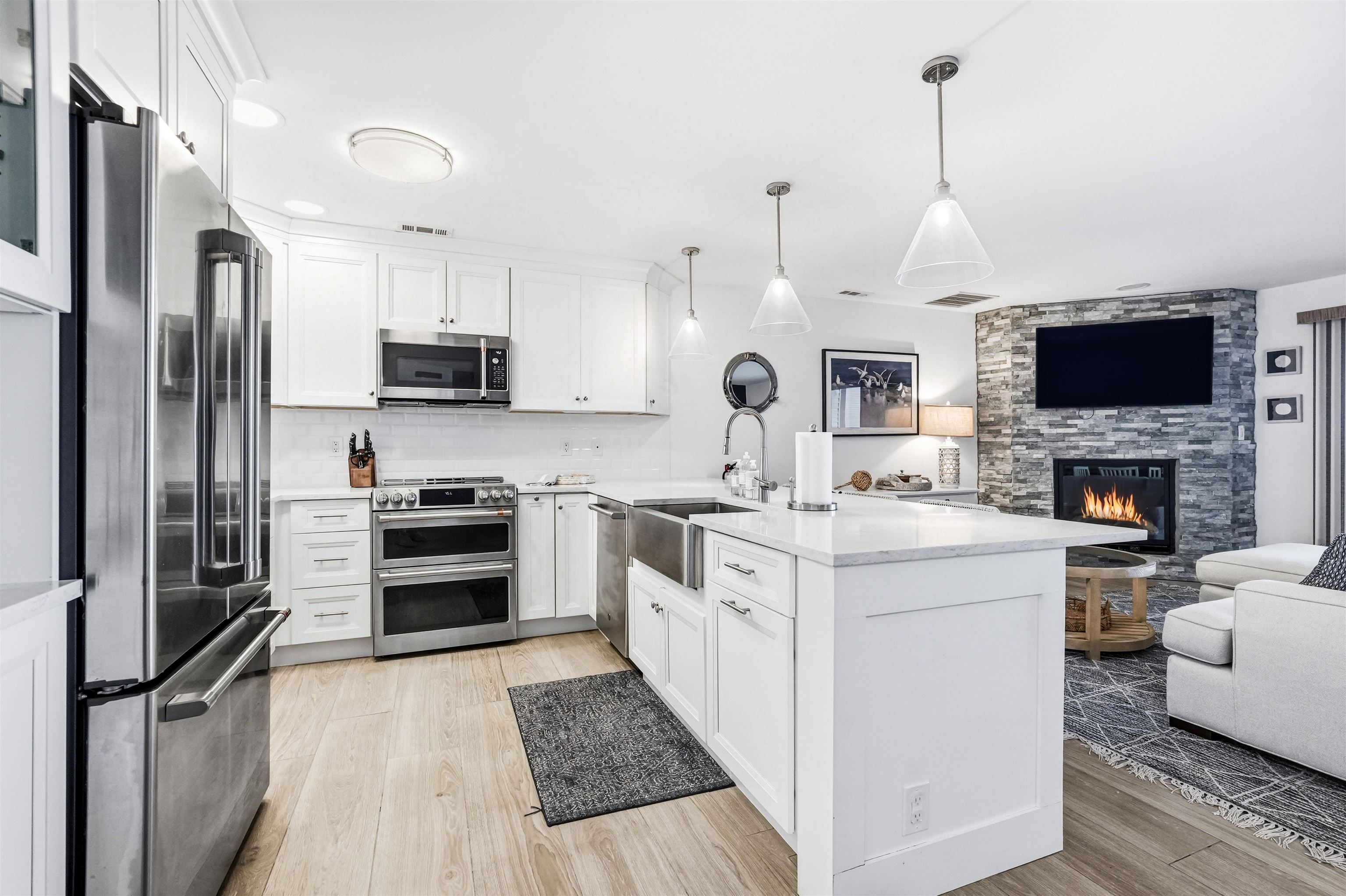 902 Ocean, Unit 906 Cape May, NJ 08204 - Photo 10 of 47 a kitchen with stainless steel appliances a stove refrigerator sink and microwave
