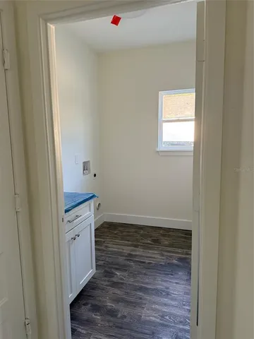 a room with wooden floor and window