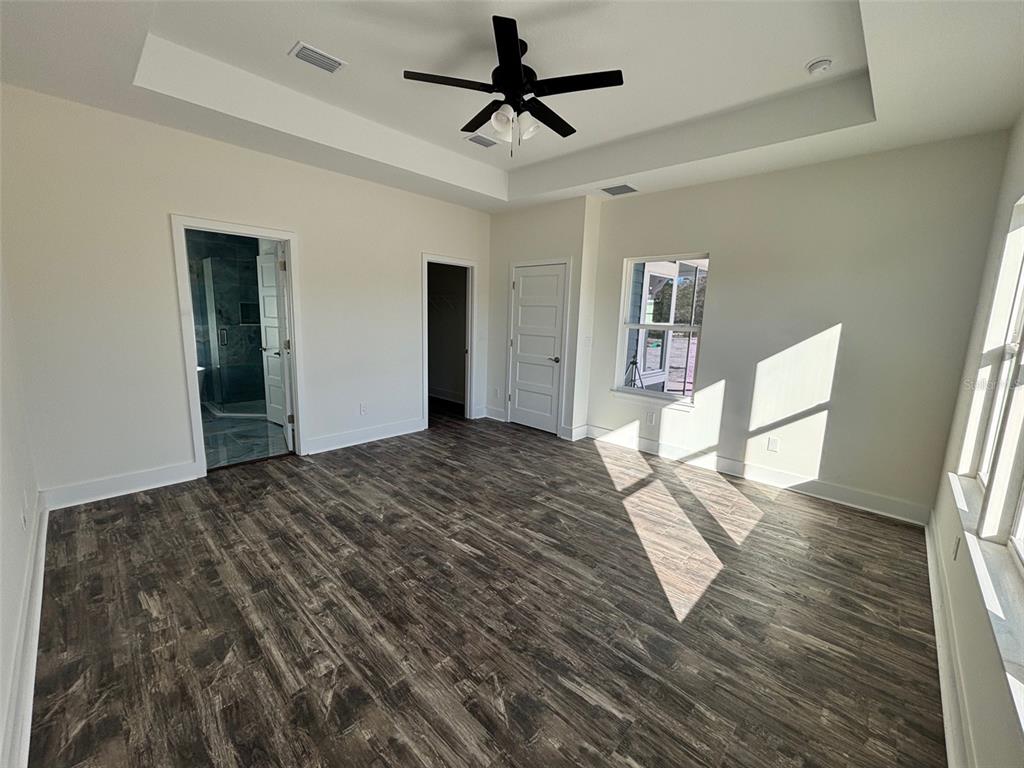 5949 South E County Road 21B Keystone Heights, FL 32656 - Photo 13 of 30 a bedroom with a bed and a chandelier