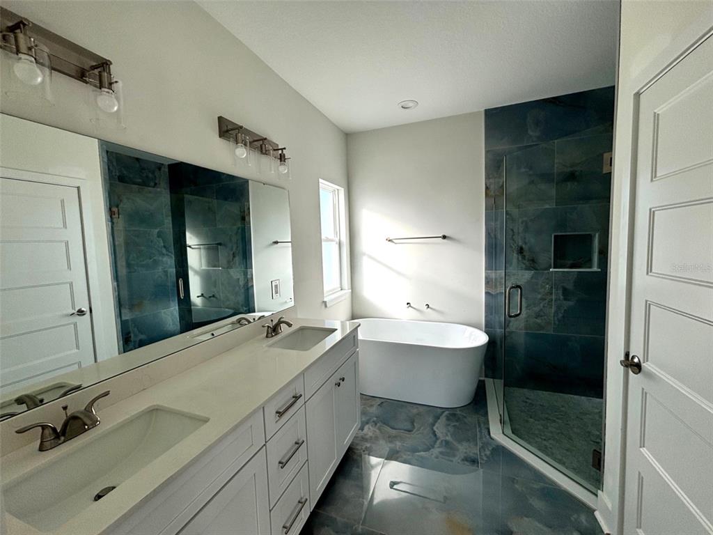 5949 South E County Road 21B Keystone Heights, FL 32656 - Photo 14 of 30 a bathroom with a double vanity sink and mirror with shower