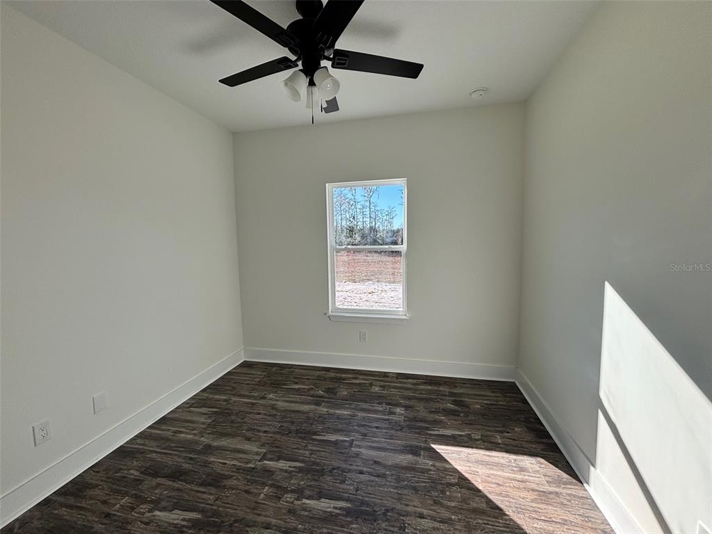5949 South E County Road 21B Keystone Heights, FL 32656 - Photo 16 of 30 an empty room with a ceiling fan and window