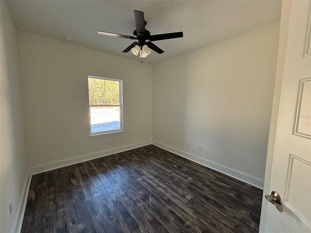 5949 South E County Road 21B Keystone Heights, FL 32656 - Photo 22 of 30 a view of empty room with wooden floor and fan