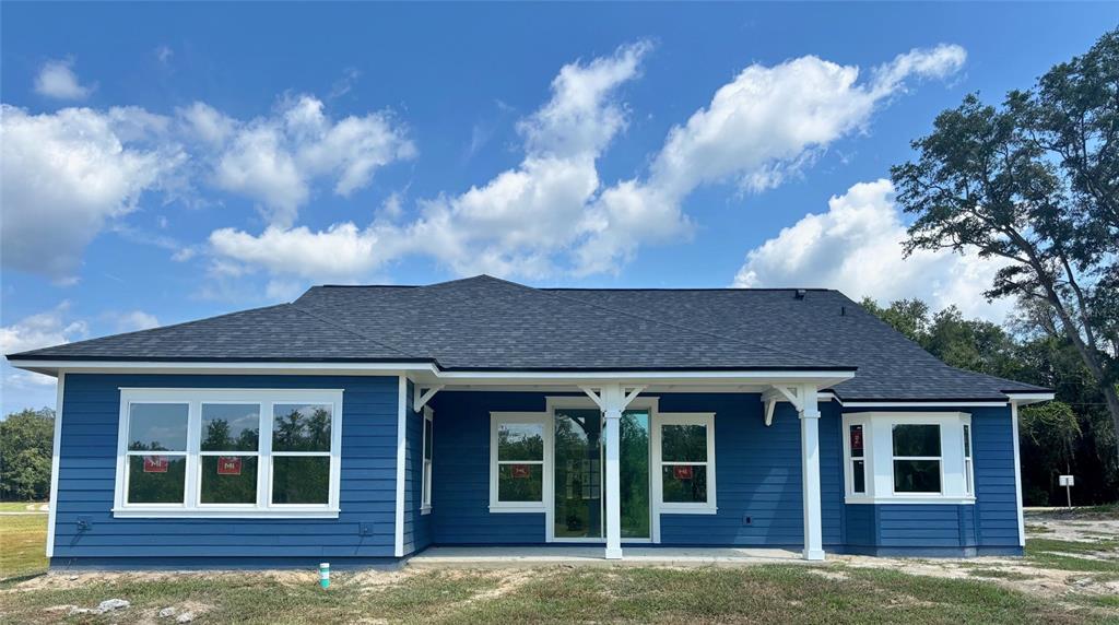 5949 South E County Road 21B Keystone Heights, FL 32656 - Photo 26 of 30 a view of a brick house with large windows and a large tree