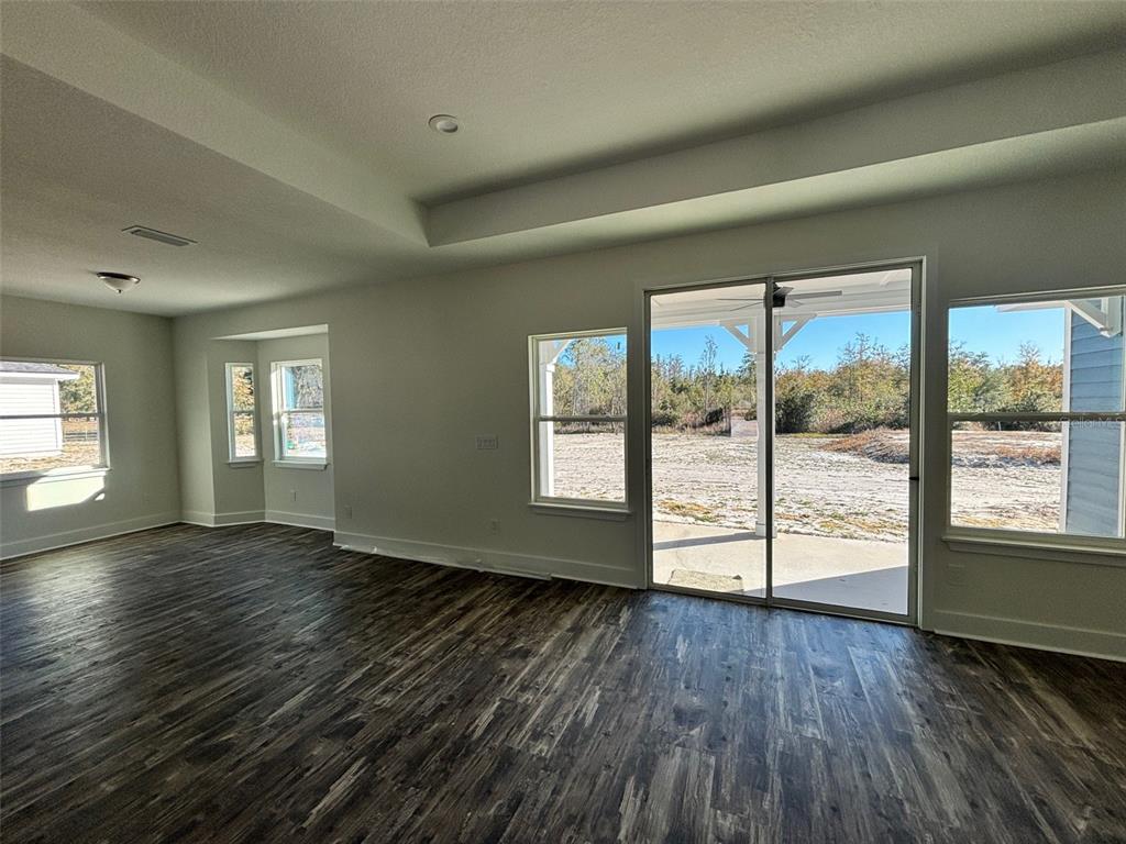 5949 South E County Road 21B Keystone Heights, FL 32656 - Photo 10 of 30 a view of an empty room with wooden floor and a window