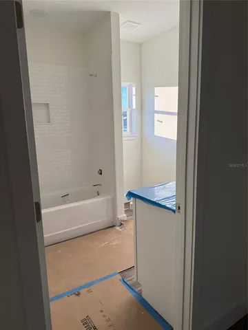 a bathroom with a bathtub and a shower