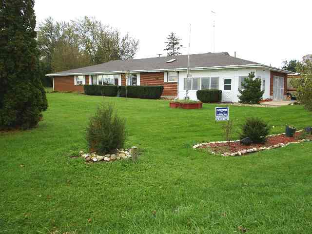 a front view of a house with a yard table and chairs