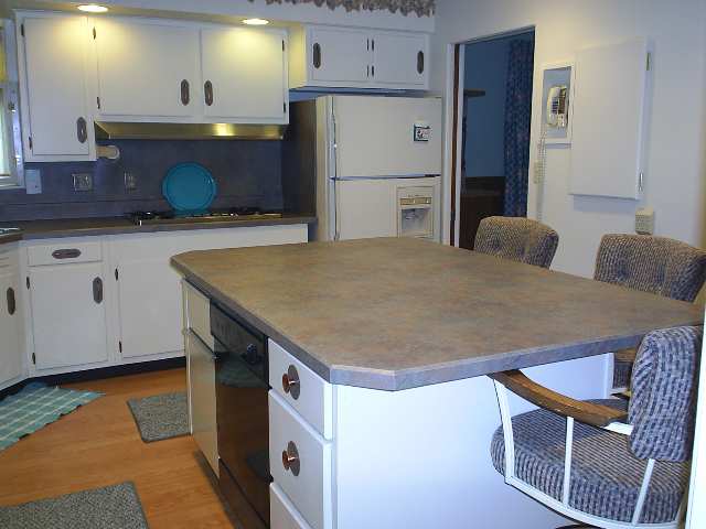 2511 West Florence Road Freeport, IL 61032 - Photo 3 of 9 a kitchen with a table chairs sink and refrigerator