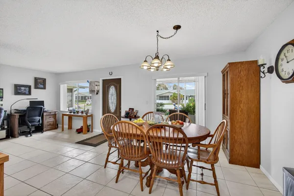 a view of a dining room with furniture and chandelier