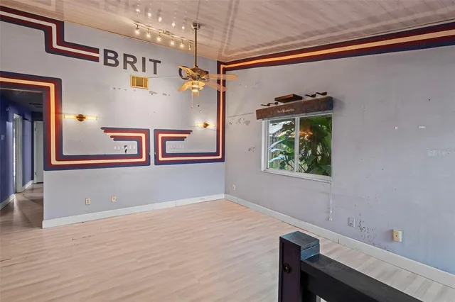 a view of a hallway with entryway and wooden floor