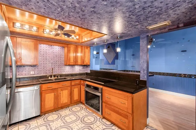 a kitchen with granite countertop a sink and cabinets
