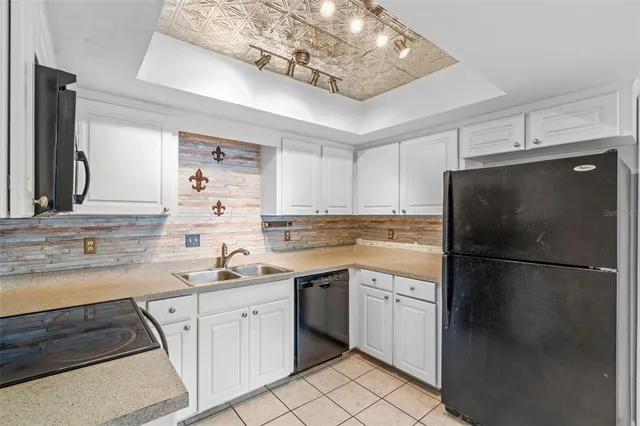 a kitchen with a sink stainless steel appliances and cabinets
