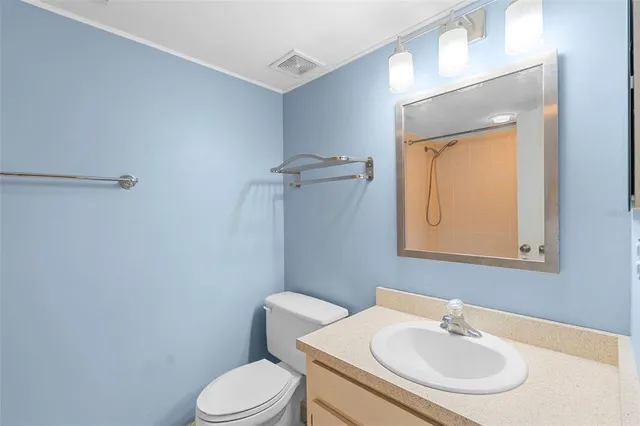 a bathroom with a sink toilet and a mirror