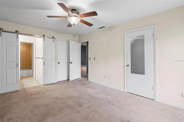 a view of empty room with ceiling fan