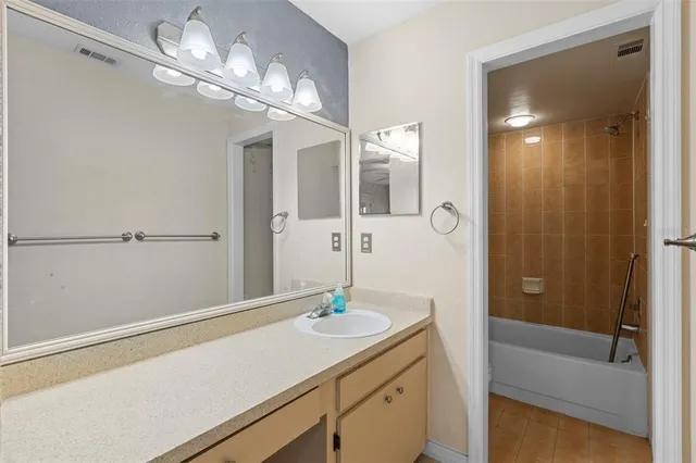 a bathroom with a sink a light fixture and a mirror
