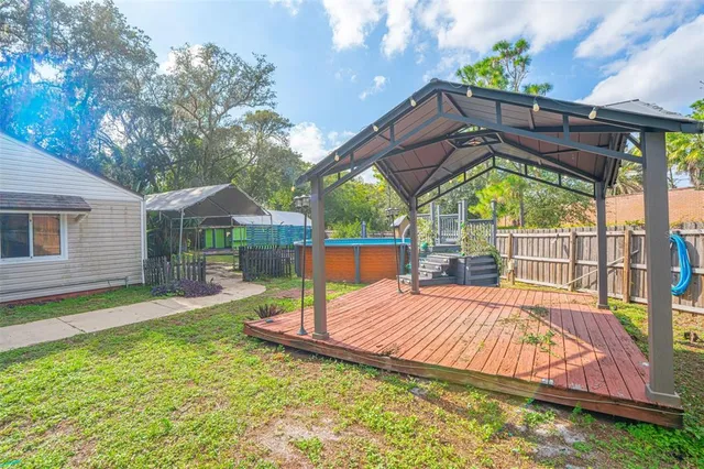 a view of a house with a yard and furniture