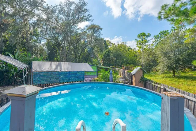 a view of a house with backyard and sitting area
