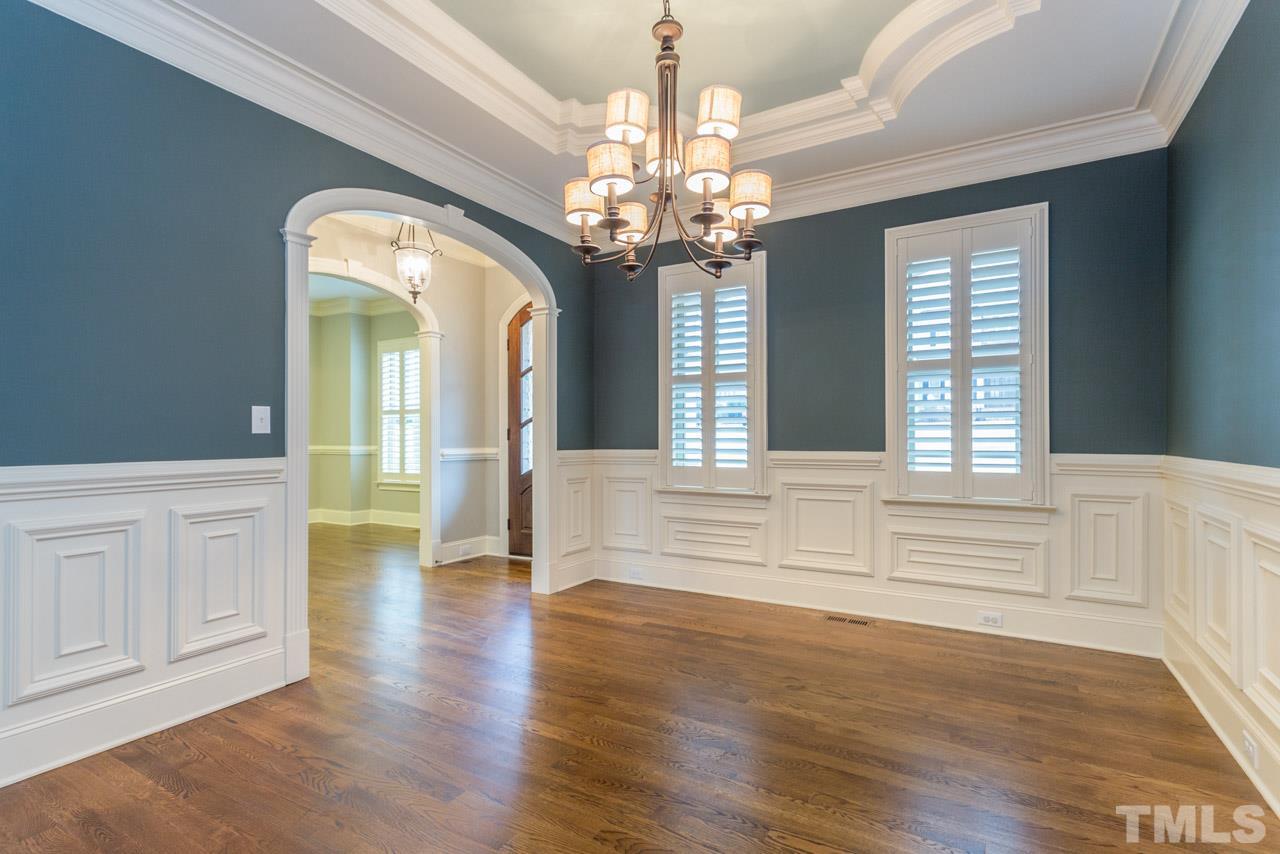 5011 Pomfret Point Raleigh, NC 27612 - Photo 2 of 25 The dining room offers hardwood floors, plantation shutters, wainscoting, crown molding, chair railing, and trey ceiling that is a work of art.