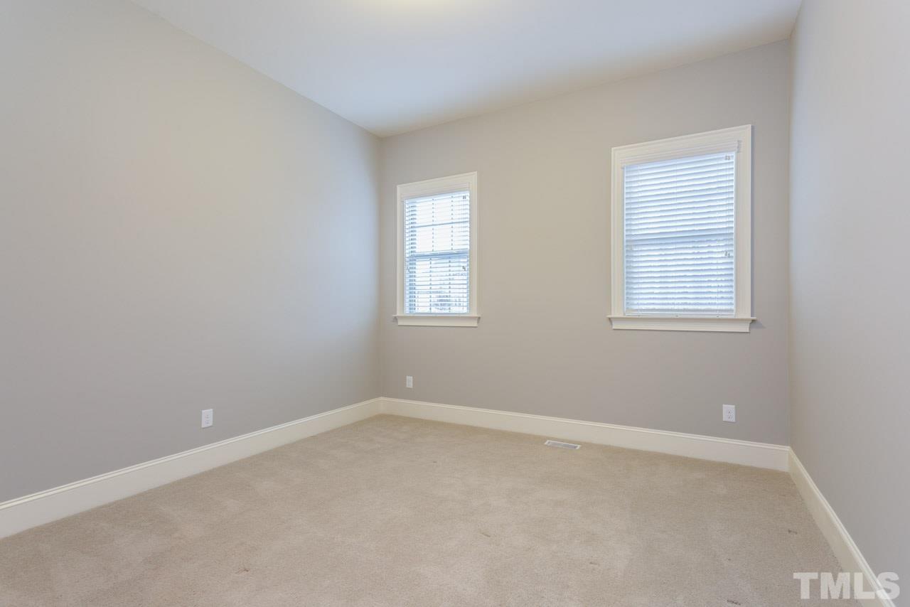 5011 Pomfret Point Raleigh, NC 27612 - Photo 11 of 25 The 1st floor guest room is located in a quiet area off the kitchen and features plantation blinds and a private bath with a walk-in shower with tile surround.
