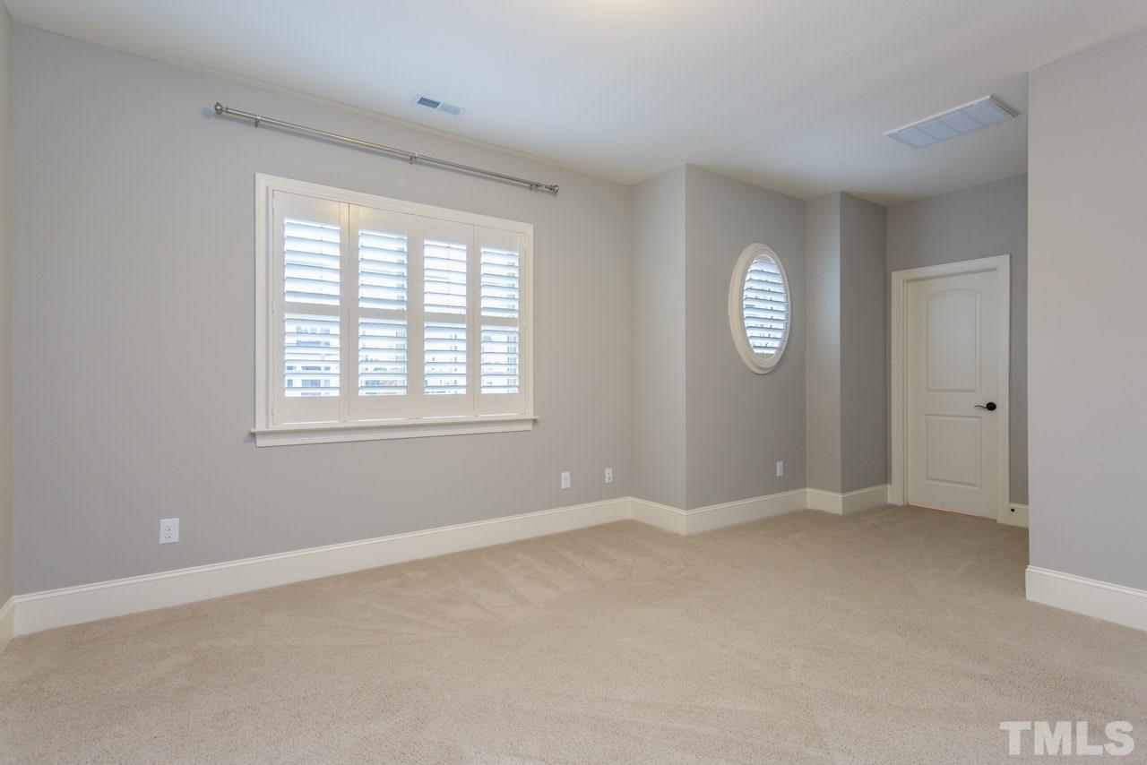 5011 Pomfret Point Raleigh, NC 27612 - Photo 14 of 25 Bedroom #3 is located on the 2nd floor and features a large walk in closet with wood shelving, a darling oval window, plantation shutters and direct access to a private full bath. (ensuite)